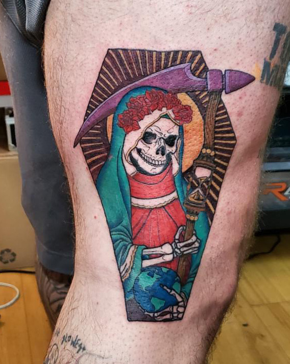 Tattoo a skeleton Mary holding a sickle and the world by tattoo artist of Sacred Mandala Studio.